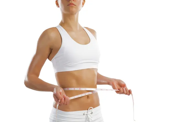 Young athletic woman measuring waist — Stock Photo, Image