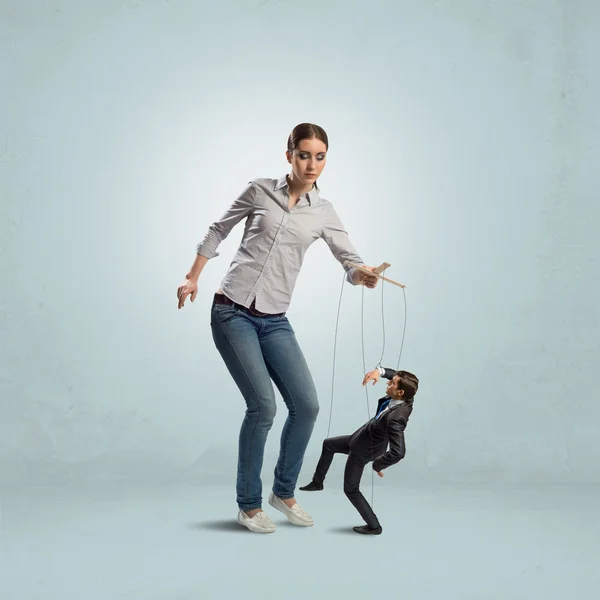 Puppeteer controls a businessman — Stock Photo, Image