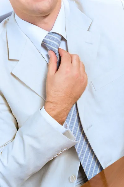 Businessman corrects a tie themselves — Stock Photo, Image