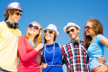 group of young people wearing sunglasses and hat
