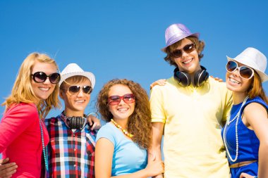 group of young people wearing sunglasses and hat