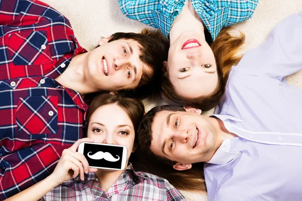 Four young men lie together — Stock Photo, Image