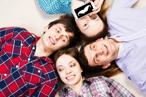 Four young men lie together — Stock Photo, Image