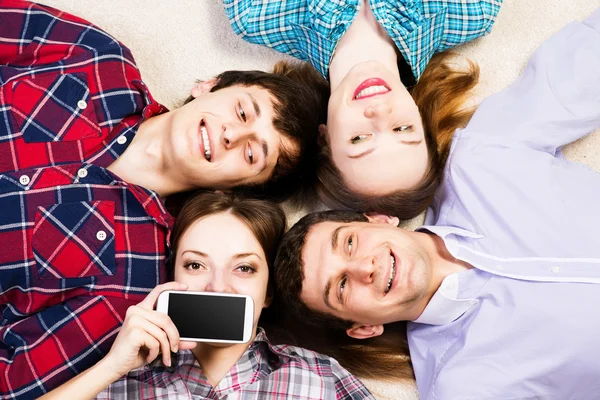 Four young men lie together — Stock Photo, Image