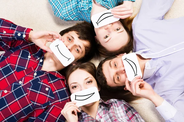 Four young men lie together — Stock Photo, Image