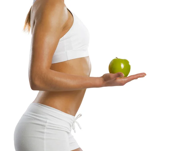 Young attractive sporty woman with green apple — Stok fotoğraf