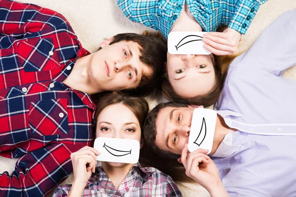 Four young men lie together — Stock Photo, Image