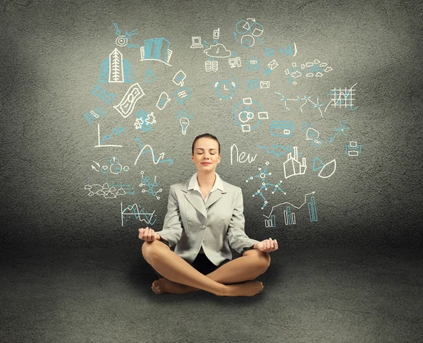 Business woman meditating on floor — Stock Photo, Image