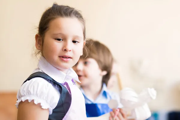 Portrait of Asian girl in apron painting — Stock Photo, Image