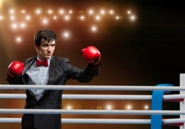 Empresário com luvas de boxe no ringue — Fotografia de Stock