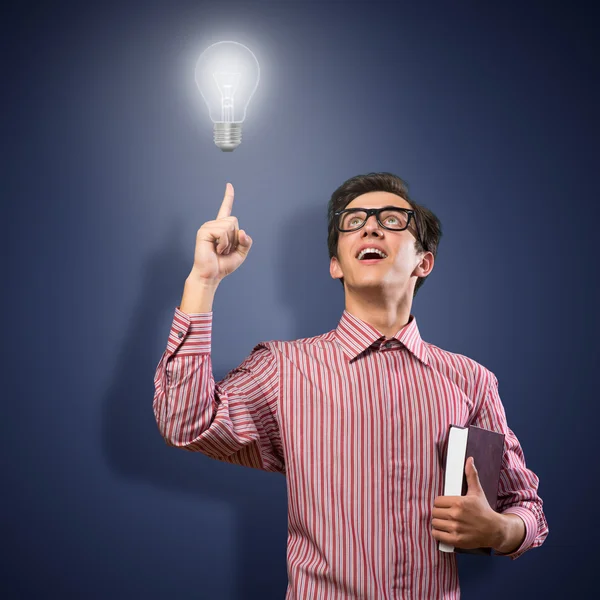 Young man holding a book — Stock Photo, Image