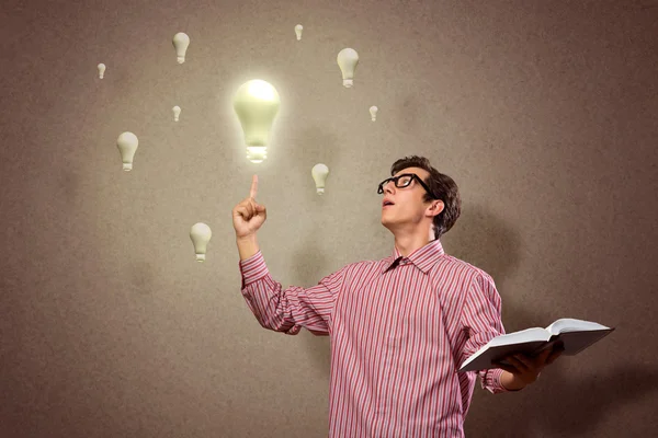 Young man holding a book — Stock Photo, Image