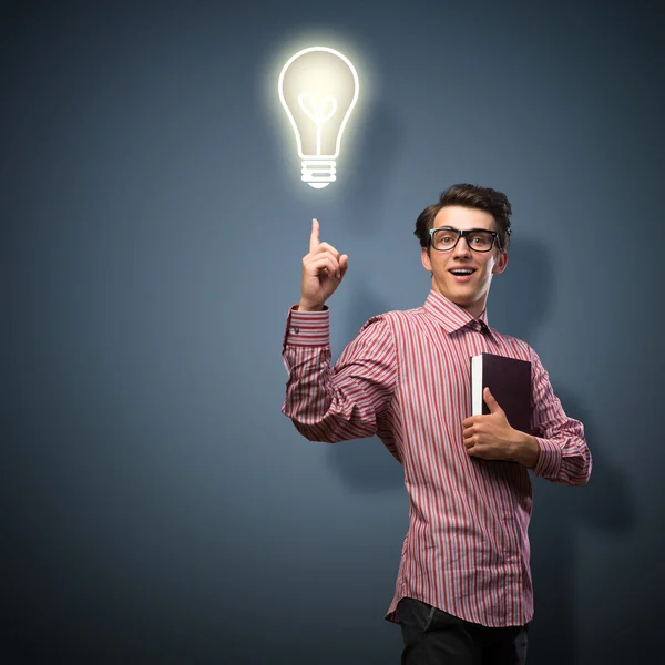 Young man holding a book — Stock Photo, Image