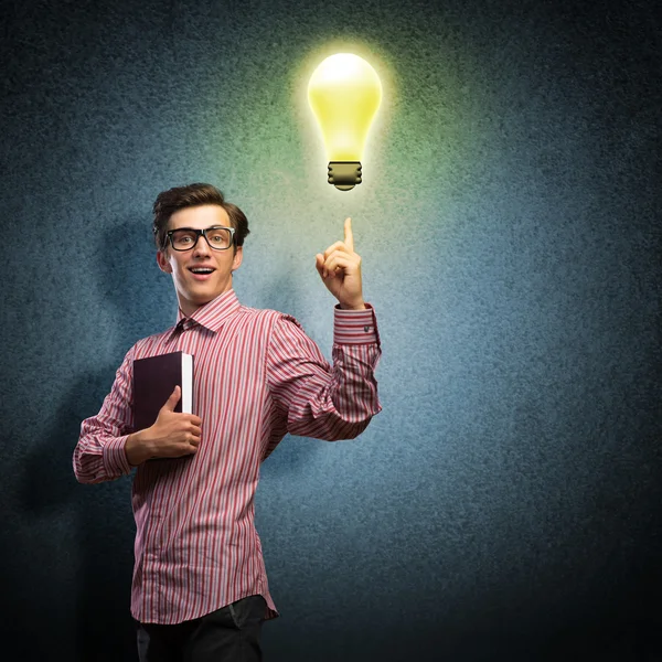 Young man holding a book — Stock Photo, Image