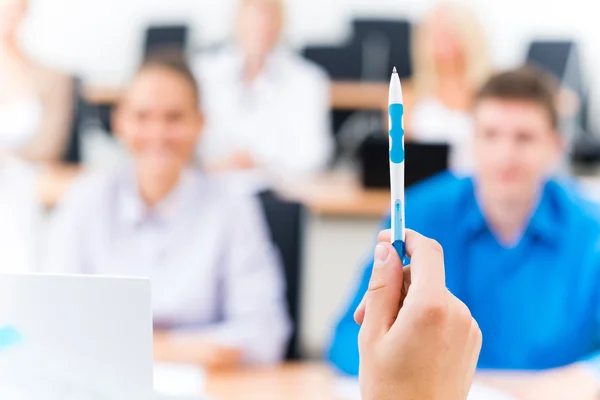 Close-up of hands of a teacher with a pen — Stock Photo, Image