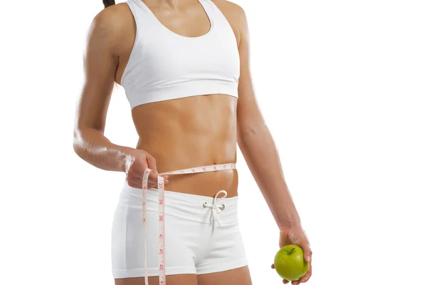 Young athletic woman holding a green apple — Stock Photo, Image