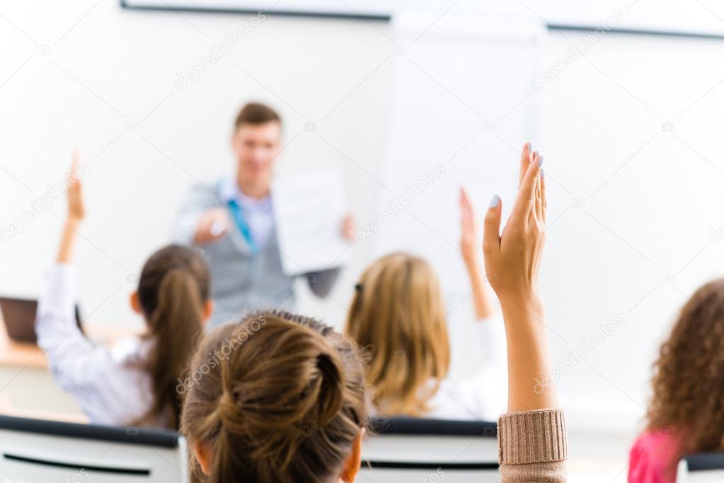 female hand raised in class