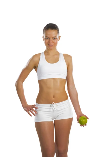 Young attractive sporty woman with green apple — Stok fotoğraf