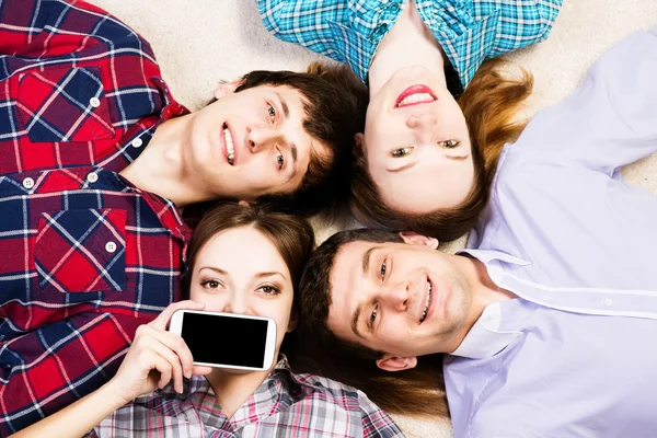 Four young men lie together — Stock Photo, Image