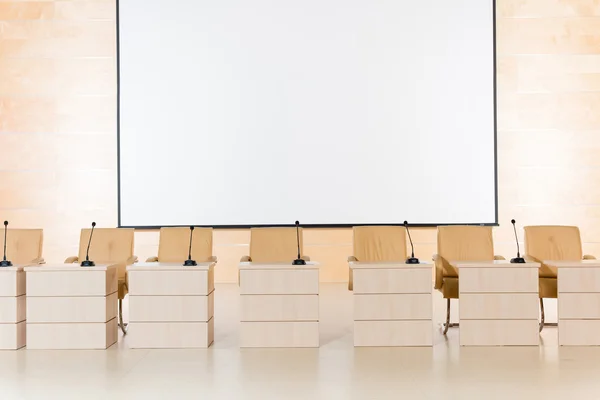 Rangée de sièges avec microphones et tables — Photo