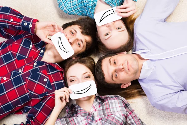 Four young men lie together — Stock Photo, Image