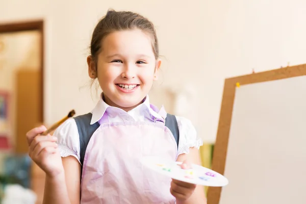Portrait of Asian girl in apron painting — Stock Photo, Image