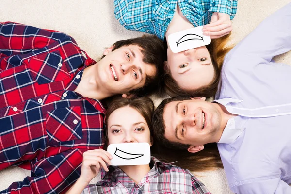 Four young men lie together — Stock Photo, Image