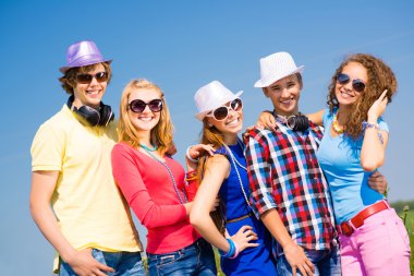 group of young people wearing sunglasses and hat