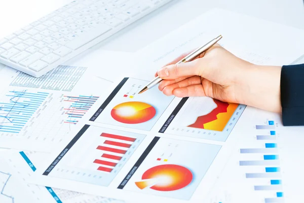 Female hand pointing to the financial growth chart — Stock Photo, Image