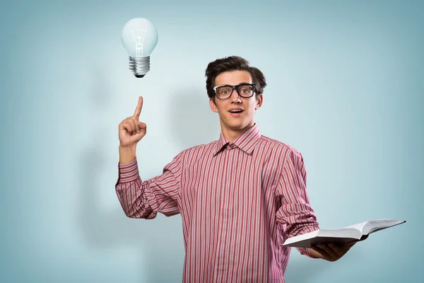 Young man holding a book — Stock Photo, Image