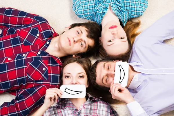 Four young men lie together — Stock Photo, Image