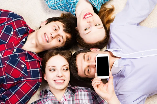 Four young men lie together — Stock Photo, Image