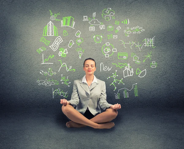 Business woman meditating on floor — Stock Photo, Image