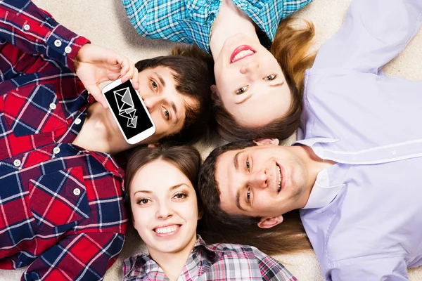 Four young men lie together — Stock Photo, Image