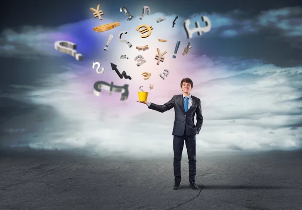 Businessman holding bucket with currency signs — Stock Photo, Image