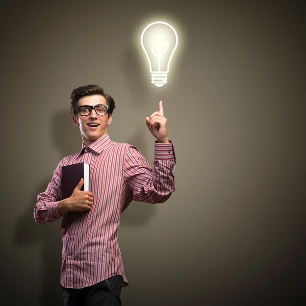 Young man holding a book — Stock Photo, Image