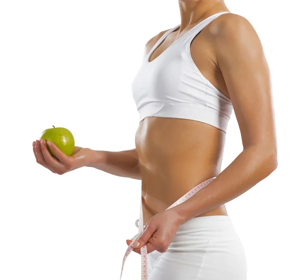Jonge atletische vrouw met een groene appel — Stockfoto