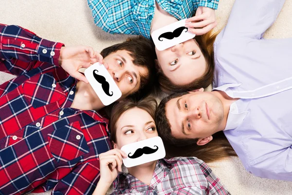 Four young men lie together — Stock Photo, Image