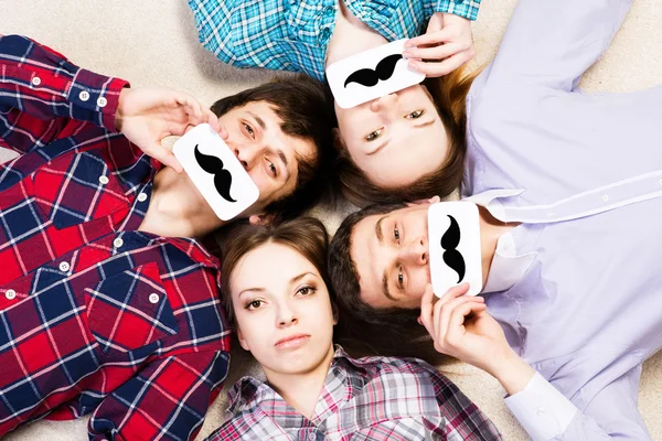 Four young men lie together — Stock Photo, Image