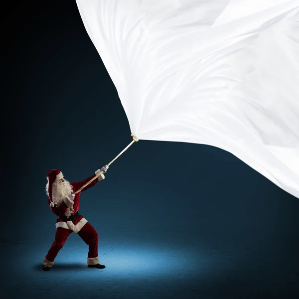 Weihnachtsmann zieht die Fahne — Stockfoto