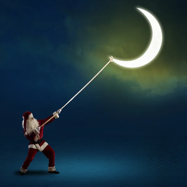 Santa Claus pulls the moon — Stock Photo, Image