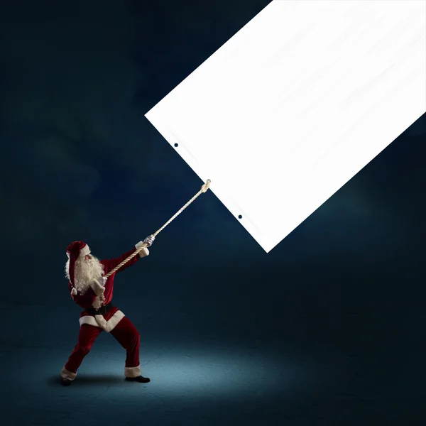 Le Père Noël tire la bannière — Photo