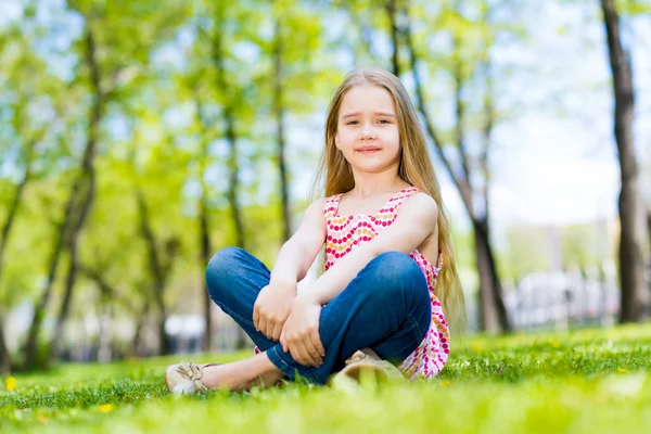 Portret van een glimlachende meisje in een park — Stockfoto