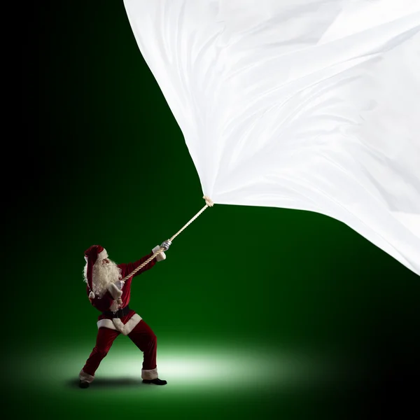 Weihnachtsmann zieht die Fahne — Stockfoto