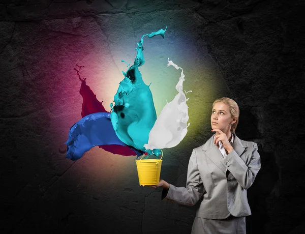 Businesswoman holding bucket — Stock Photo, Image