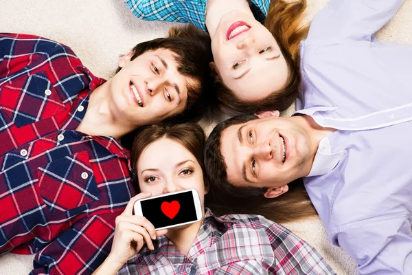 Four young men lie together — Stock Photo, Image