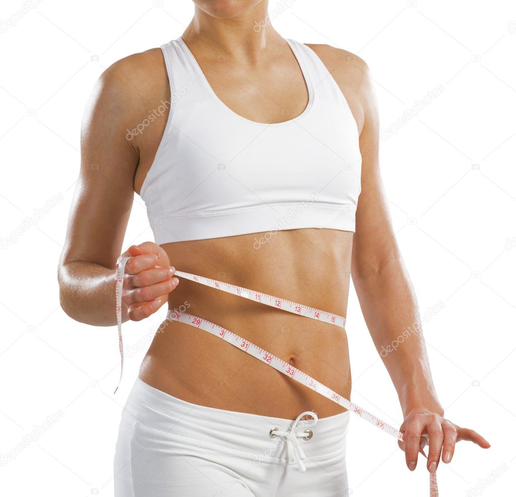 Young athletic woman measuring waist