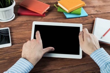 Tabletli bir işadamı, ofiste çalışıyor.