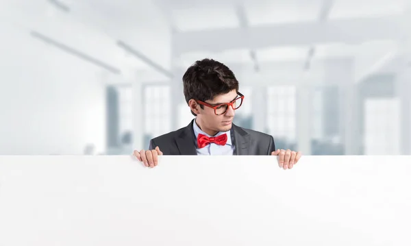 Young businessman holds a banner — Stock Photo, Image