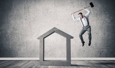 Taştan ev silueti boş odada gerçek halı sigortasının sembolü olarak duruyor.